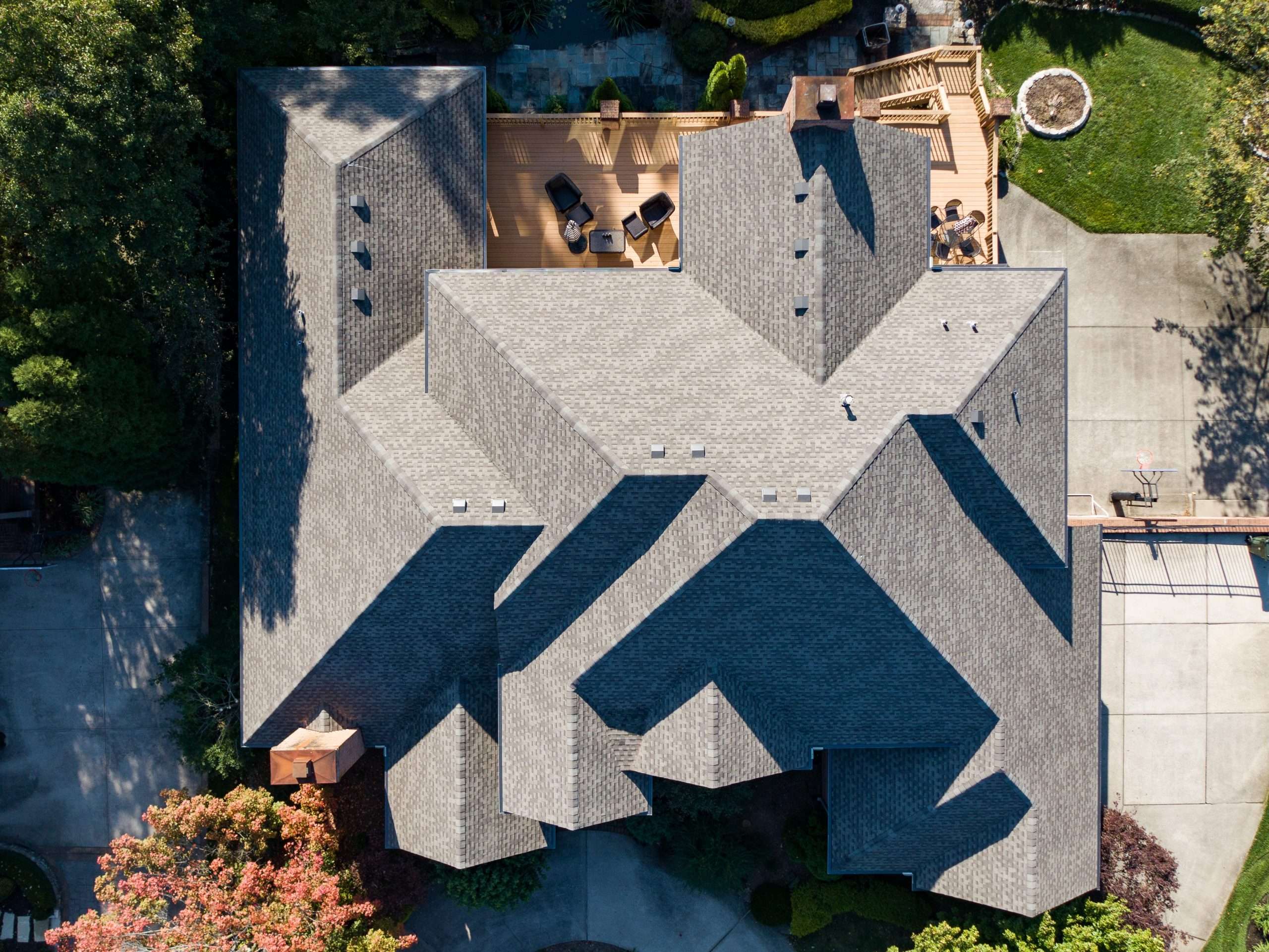 Aerial view of a beautifully installed residential roof, highlighting AIC Roofing’s craftsmanship.