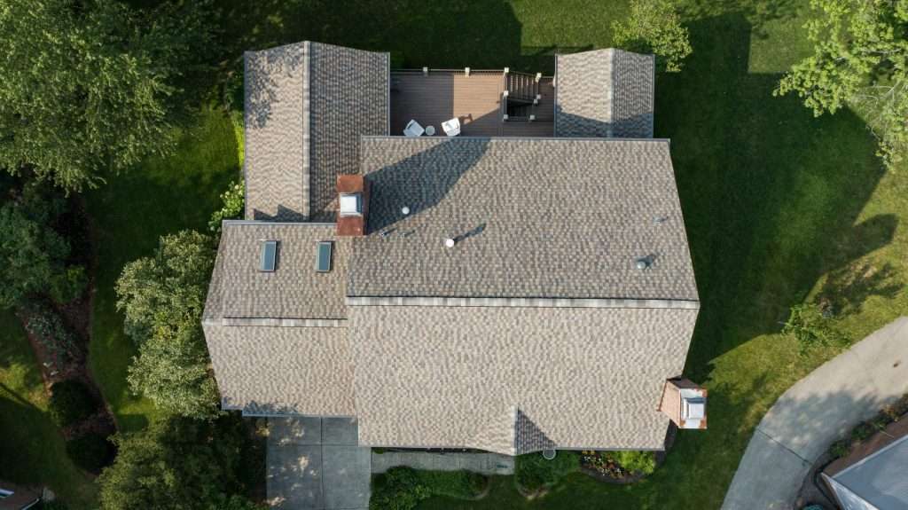 Top-down view of a recently replaced residential roof in Lexington, KY, showcasing high-quality roofing by AIC Roofing & Construction