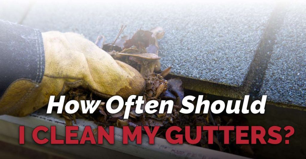 Close-up of clean gutters along a house roofline with clear skies above. Text overlay says “How Often Should I Clean My Gutters?”