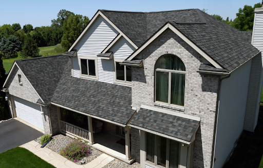 Two-story Richmond, KY home with newly installed asphalt shingle roof by AIC Roofing.
