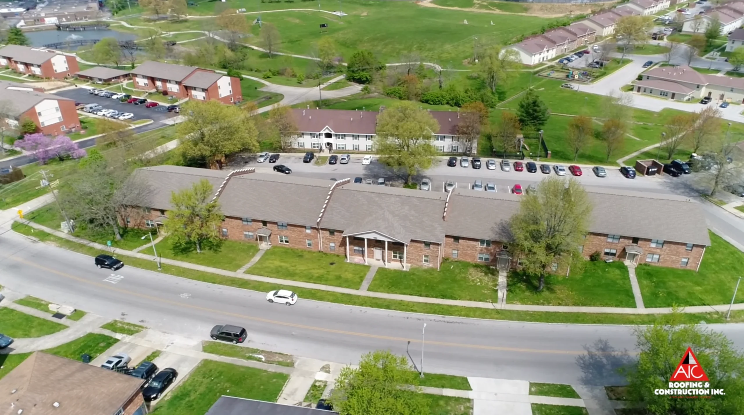 Aerial view of an apartment roof replacement in Lexington, Kentucky, featuring Weathered Wood-colored shingles, installed by a trusted shingle roofing contractor.