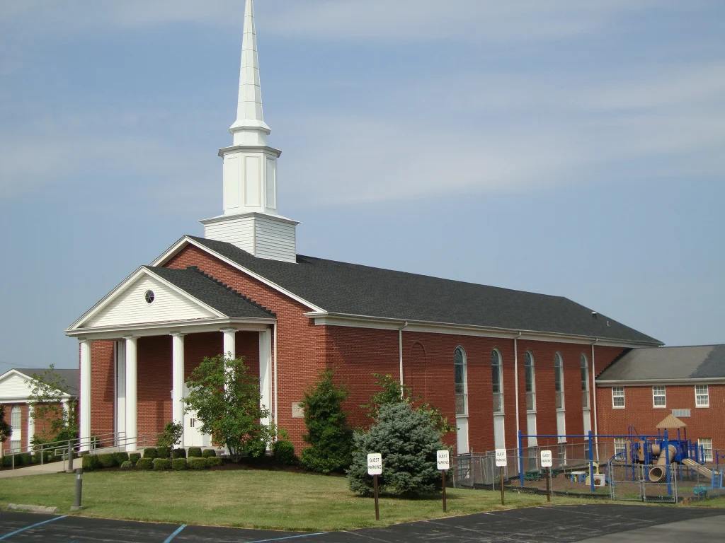 A church building with a well-maintained roof, highlighting professional roof replacement and repair services.