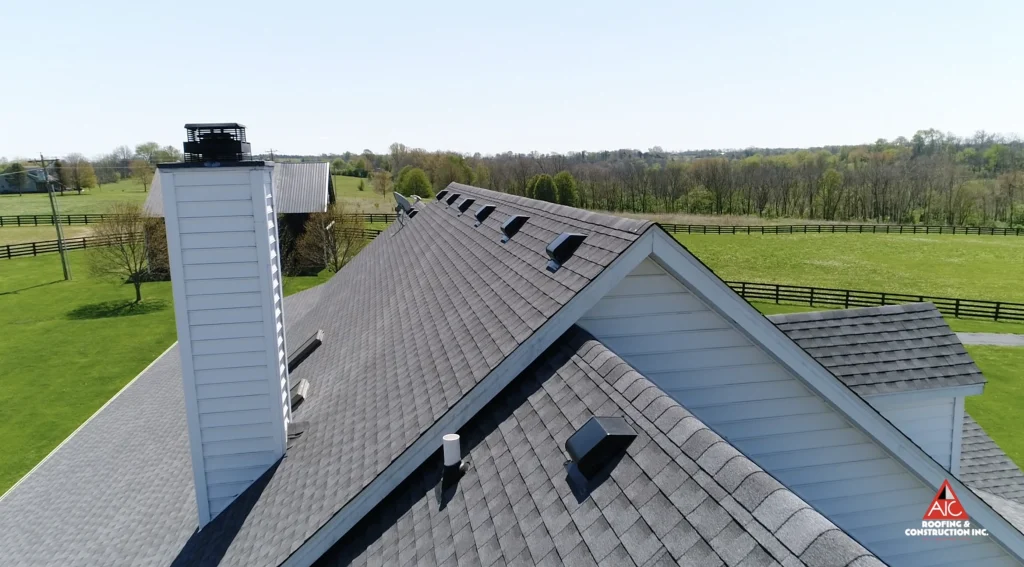 Roof with multiple vents and a chimney, showcasing potential areas prone to leaks and in need of professional roof repair services.