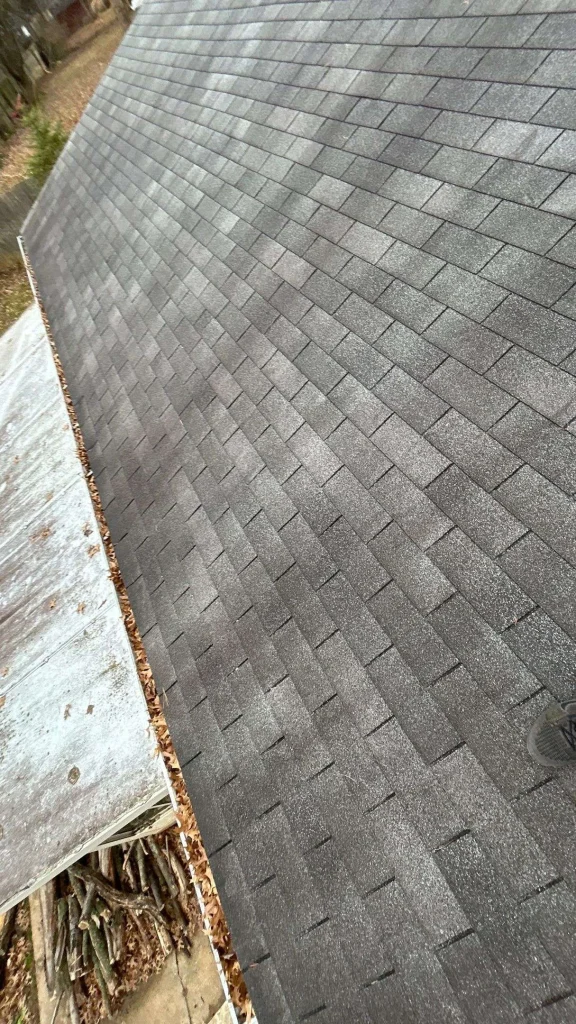 Close-up of a roof with damaged shingles in need of repair or replacement, showcasing a professional roofing solution for commercial properties.