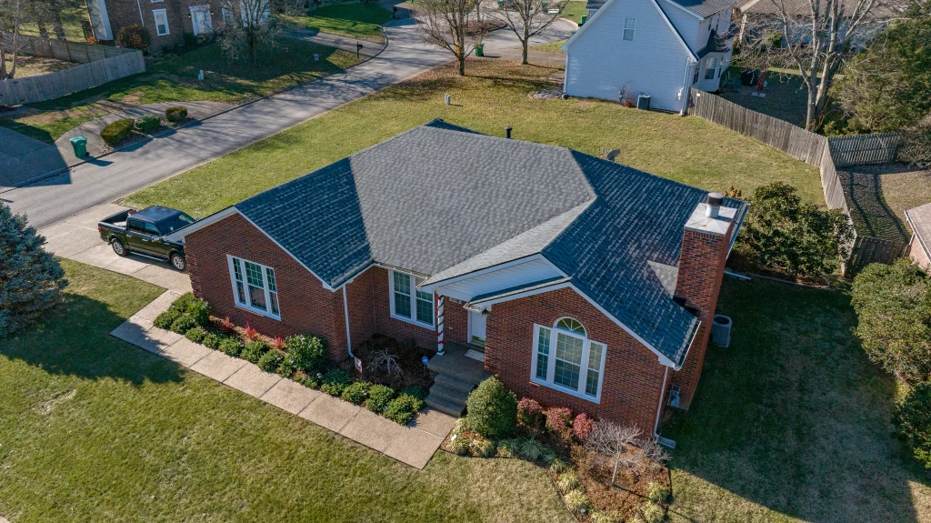 Enhance your home with a new roof – take advantage of our special offers. New shingle roof installation on a single-story brick home in Lexington, KY, showcasing AIC Roofing & Construction’s professional roofing services.