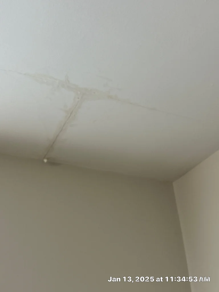 Ceiling with visible water damage caused by a leaking roof, highlighting the need for immediate roof leak repair.