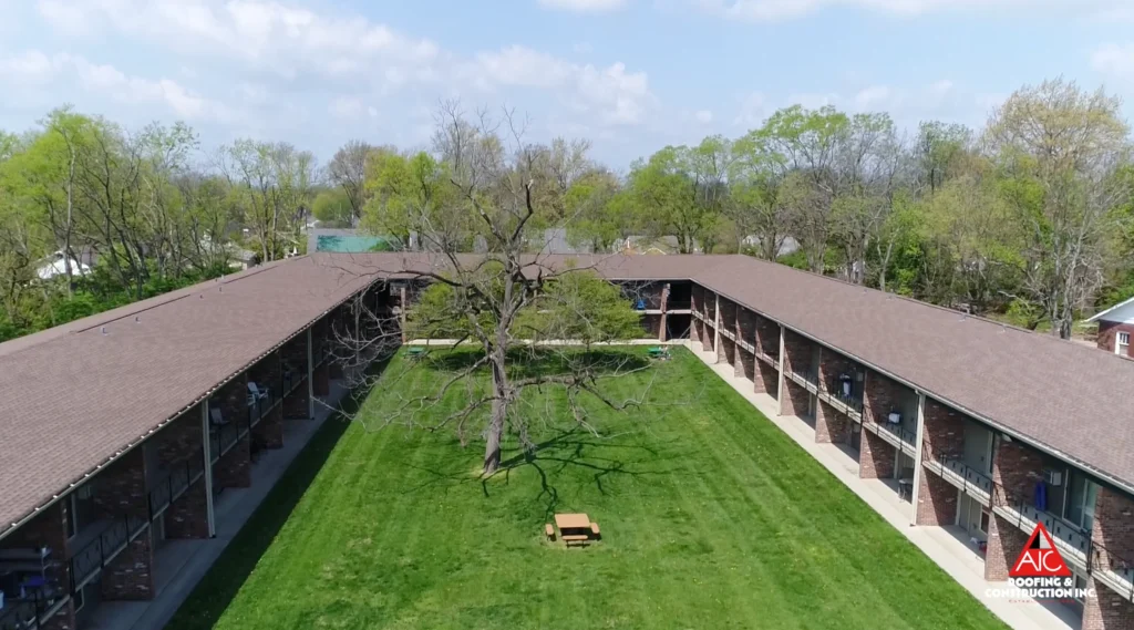 A newly installed Hickory-colored GAF shingle roof on a multifamily apartment complex in Lexington, Kentucky, showcasing a completed apartment roof replacement project.
