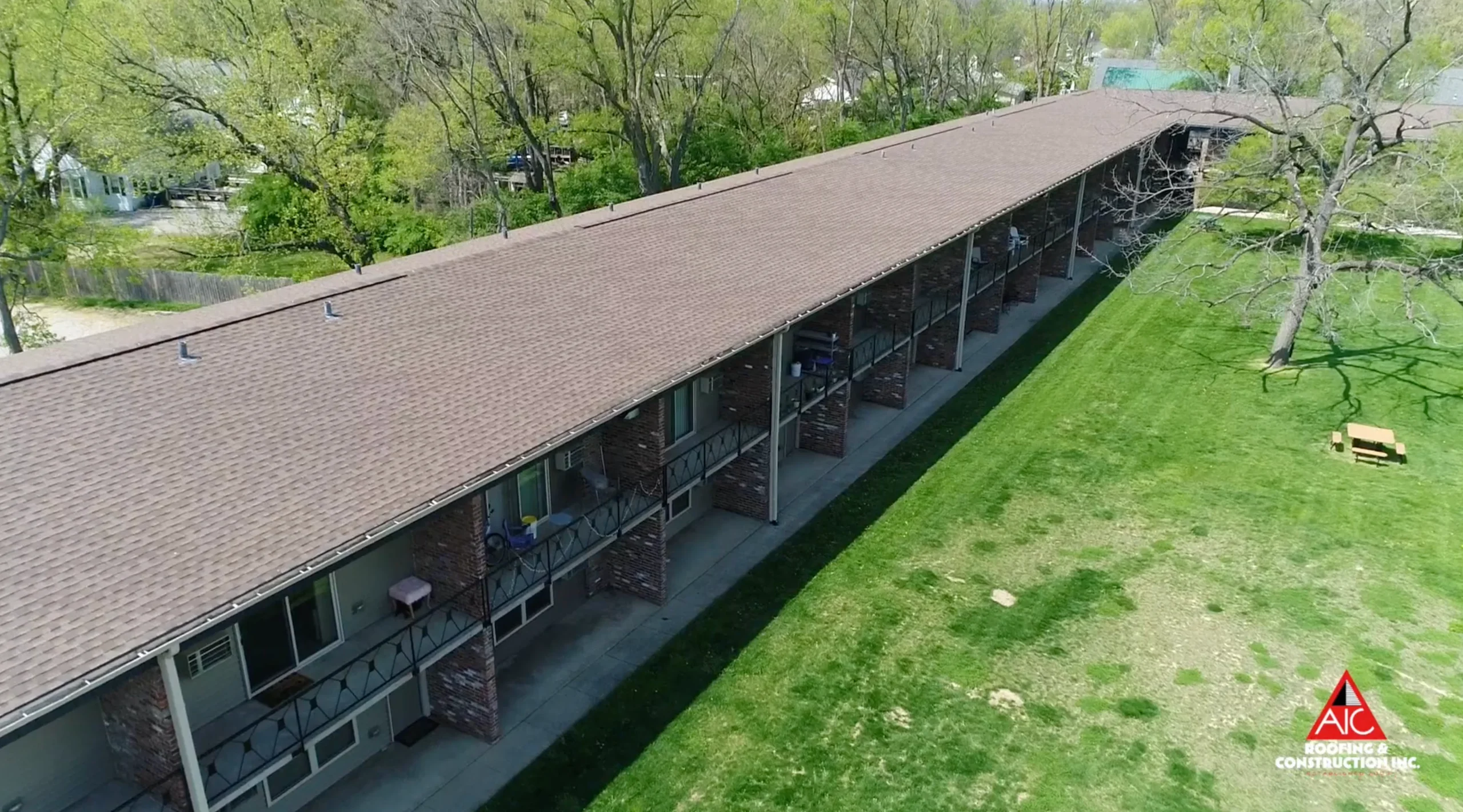 Aerial view of a multifamily roof replacement in Hickory-colored GAF shingles, installed on an apartment complex in Lexington, Kentucky for a shingle roof replacement project.