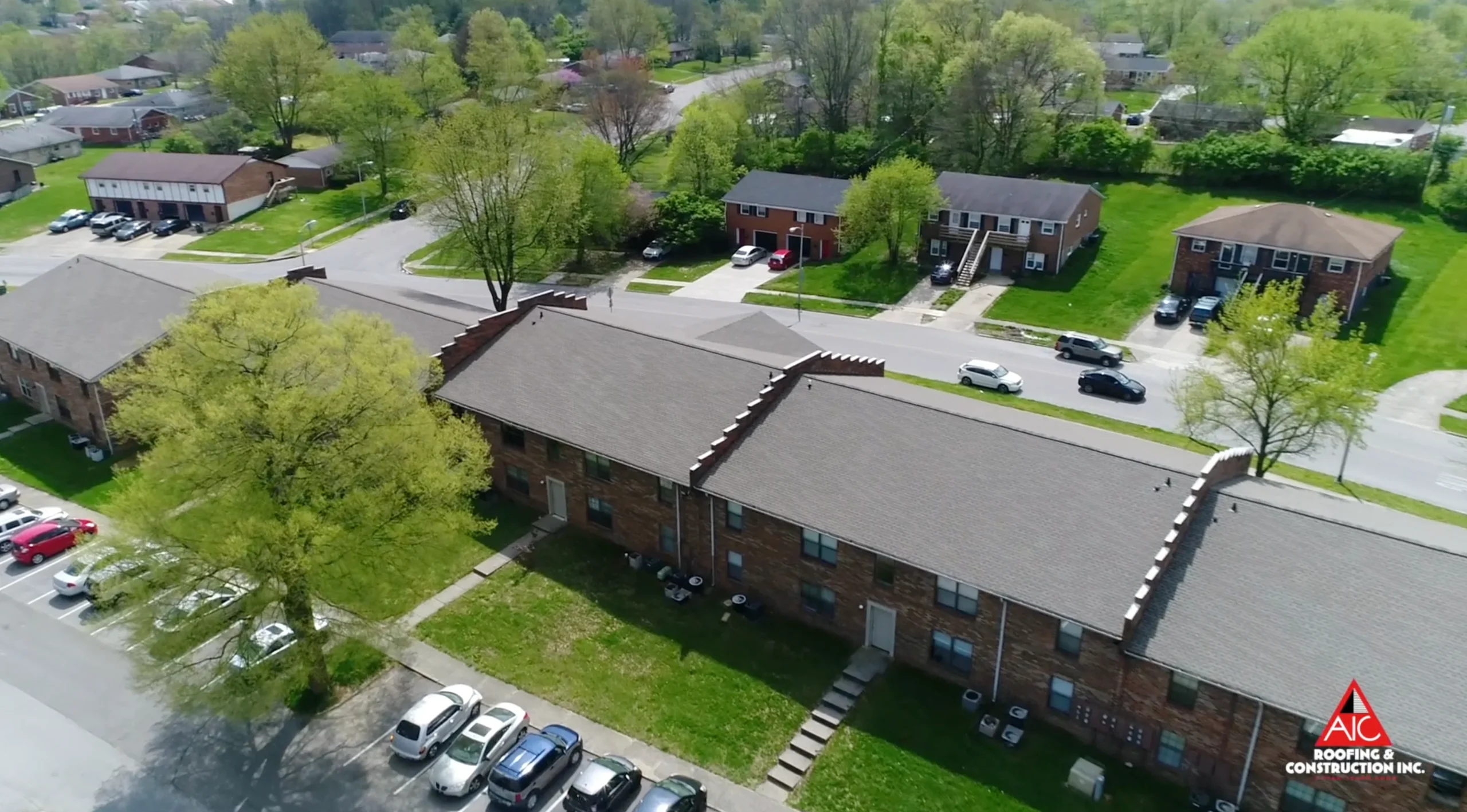 A recently completed apartment roof replacement in Lexington, Kentucky, featuring Weathered Wood-colored shingles, installed by a professional shingle roofing contractor.