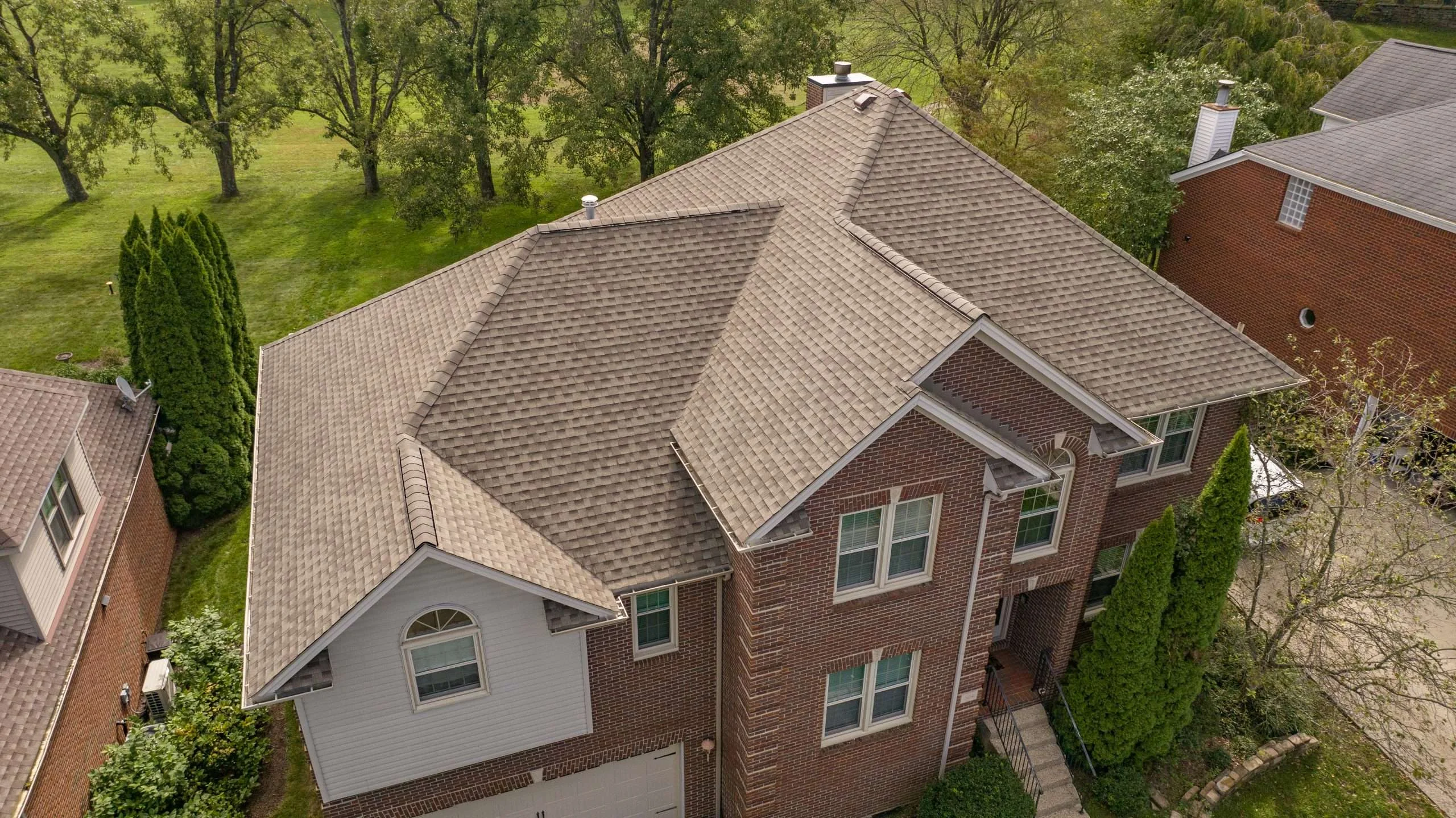 Aerial view of a roof replacement by Lexington roofing contractor using GAF Weathered Wood shingles.