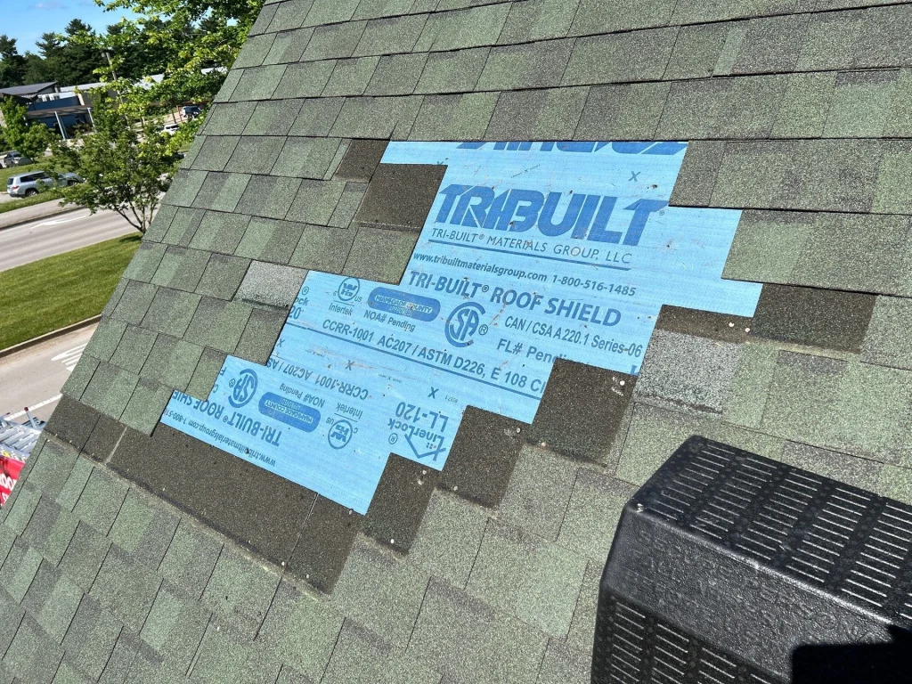 Close-up of a roof under repair with new underlayment installation in Lexington, KY, showcasing AIC Roofing & Construction’s quality roofing process.