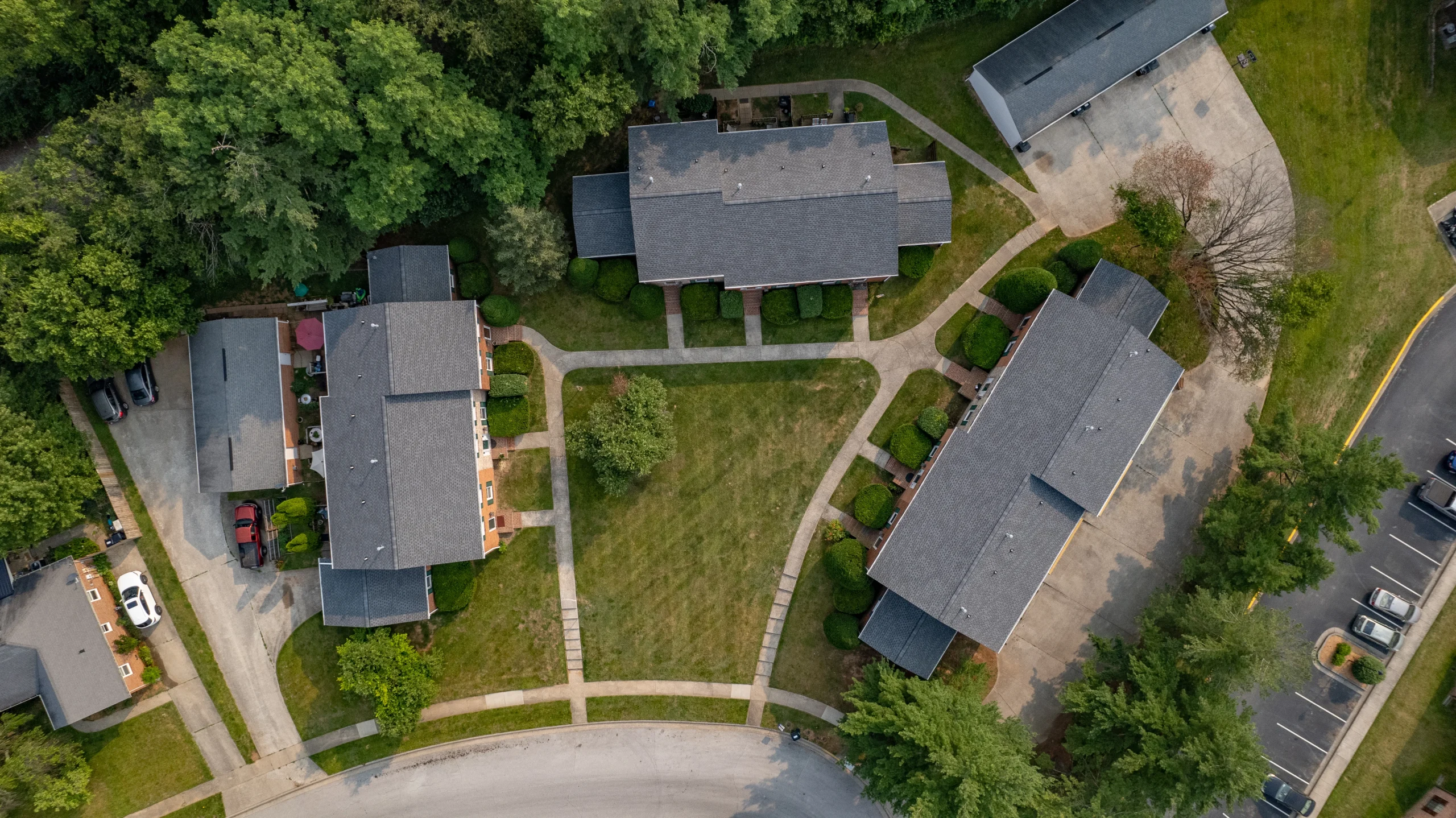 Aerial view of newly installed Pewter Gray shingle roofs on an apartment complex in Versailles, Kentucky, completed by AIC Roofing & Construction for a multifamily roof repair and replacement project.