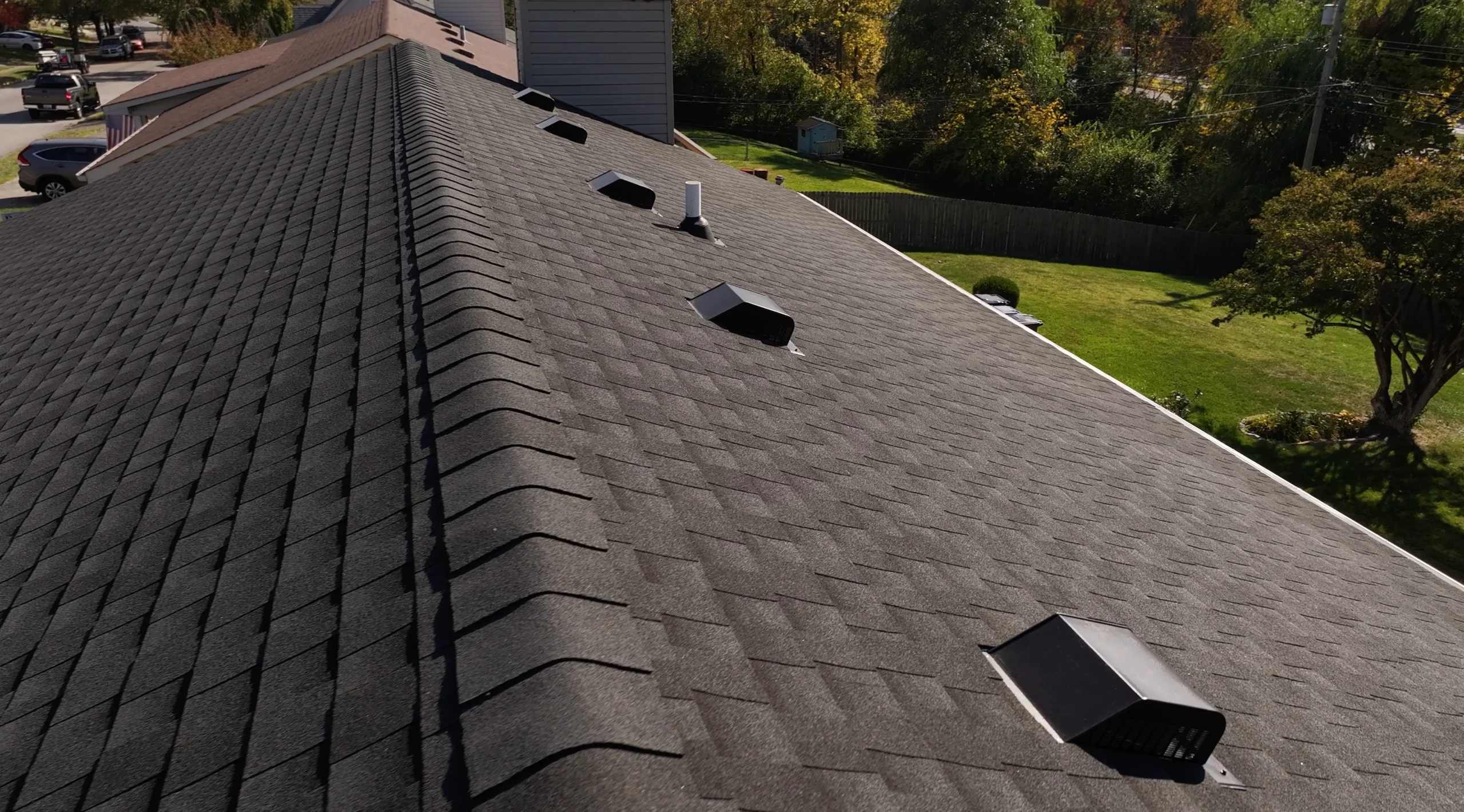 Close-up of a new roof replacement featuring GAF Timberline HDZ shingles in Charcoal, installed by a local roofing contractor.