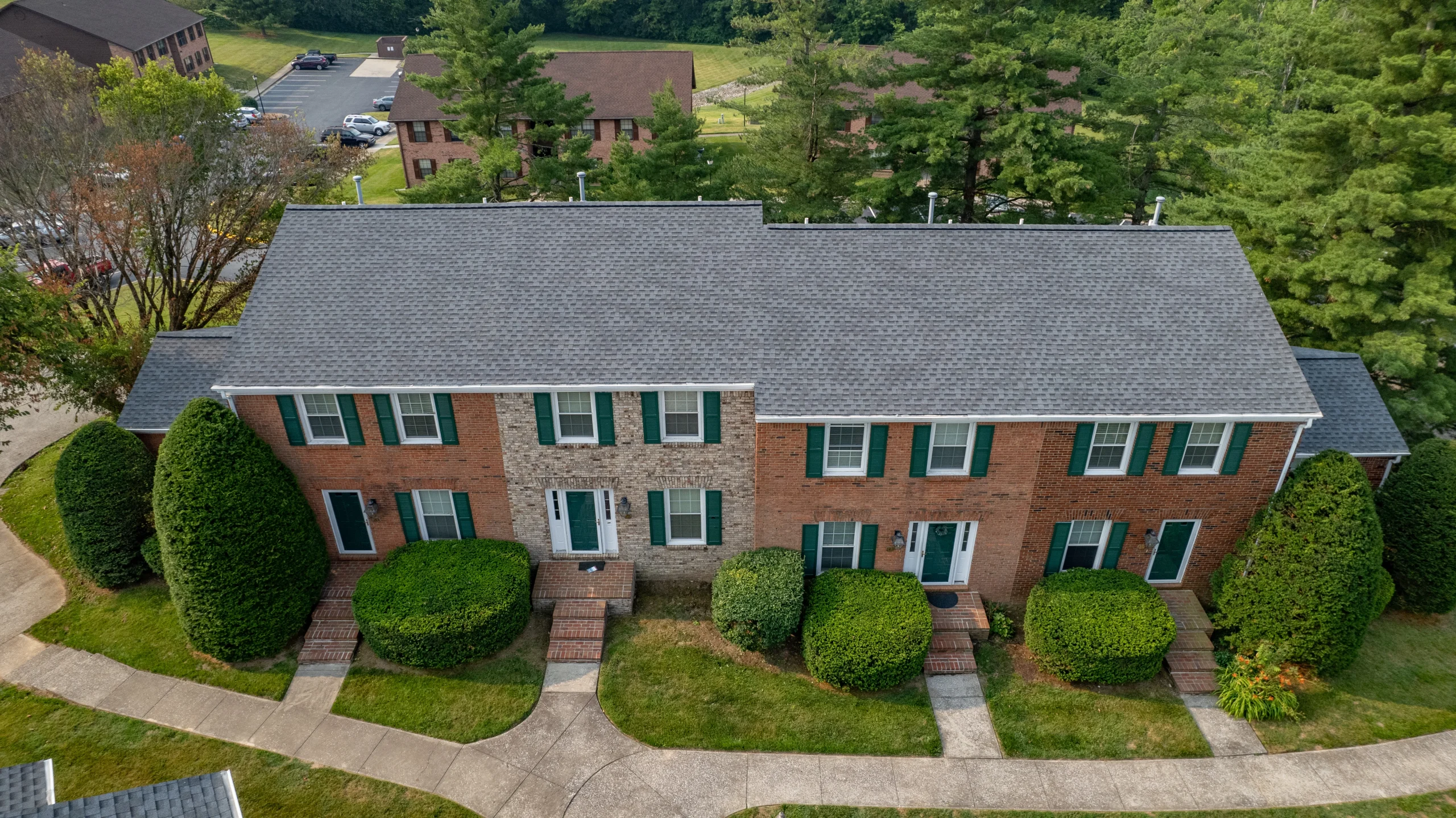 A newly installed Pewter Gray shingle roof on a Versailles, Kentucky apartment building, expertly completed by AIC Roofing & Construction for multifamily roof repair and apartment roof replacement.