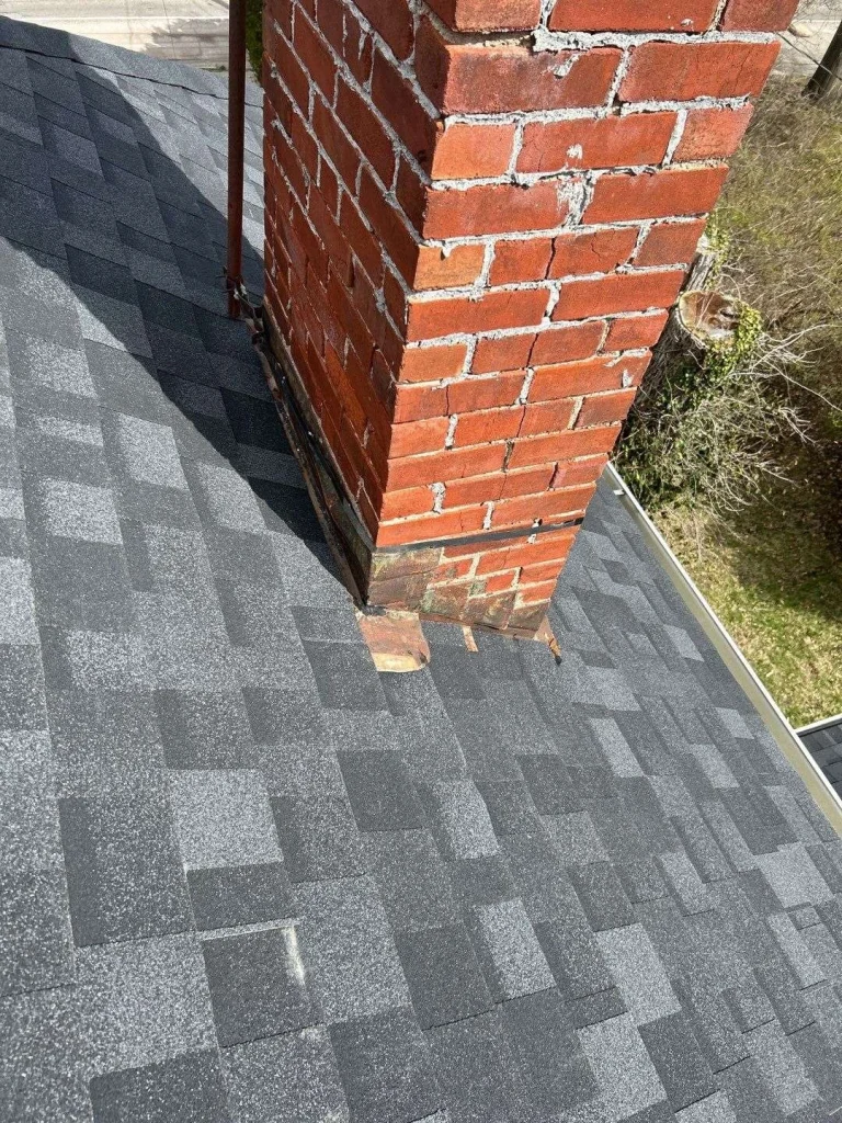 Close-up of chimney flashing on a newly installed roof in Lexington, KY, showcasing AIC Roofing & Construction’s quality roofing and siding services.