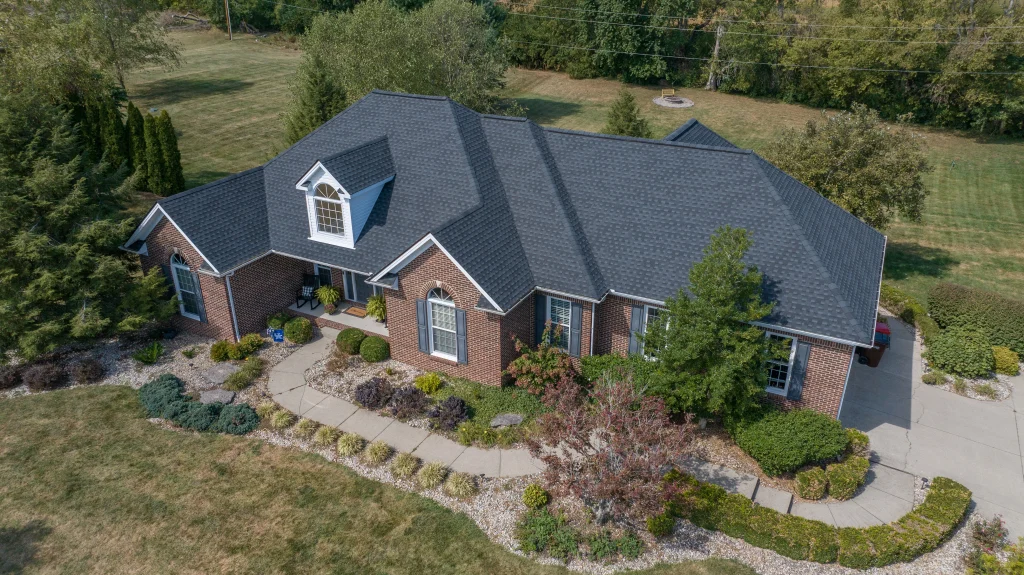A beautifully maintained brick home with a recently replaced roof, showcasing professional roofing work.