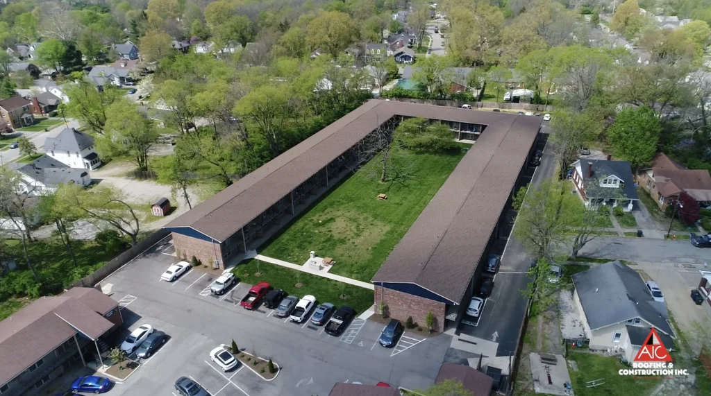 Aerial view of a large residential complex with newly replaced roofs, highlighting expert commercial roofing services.