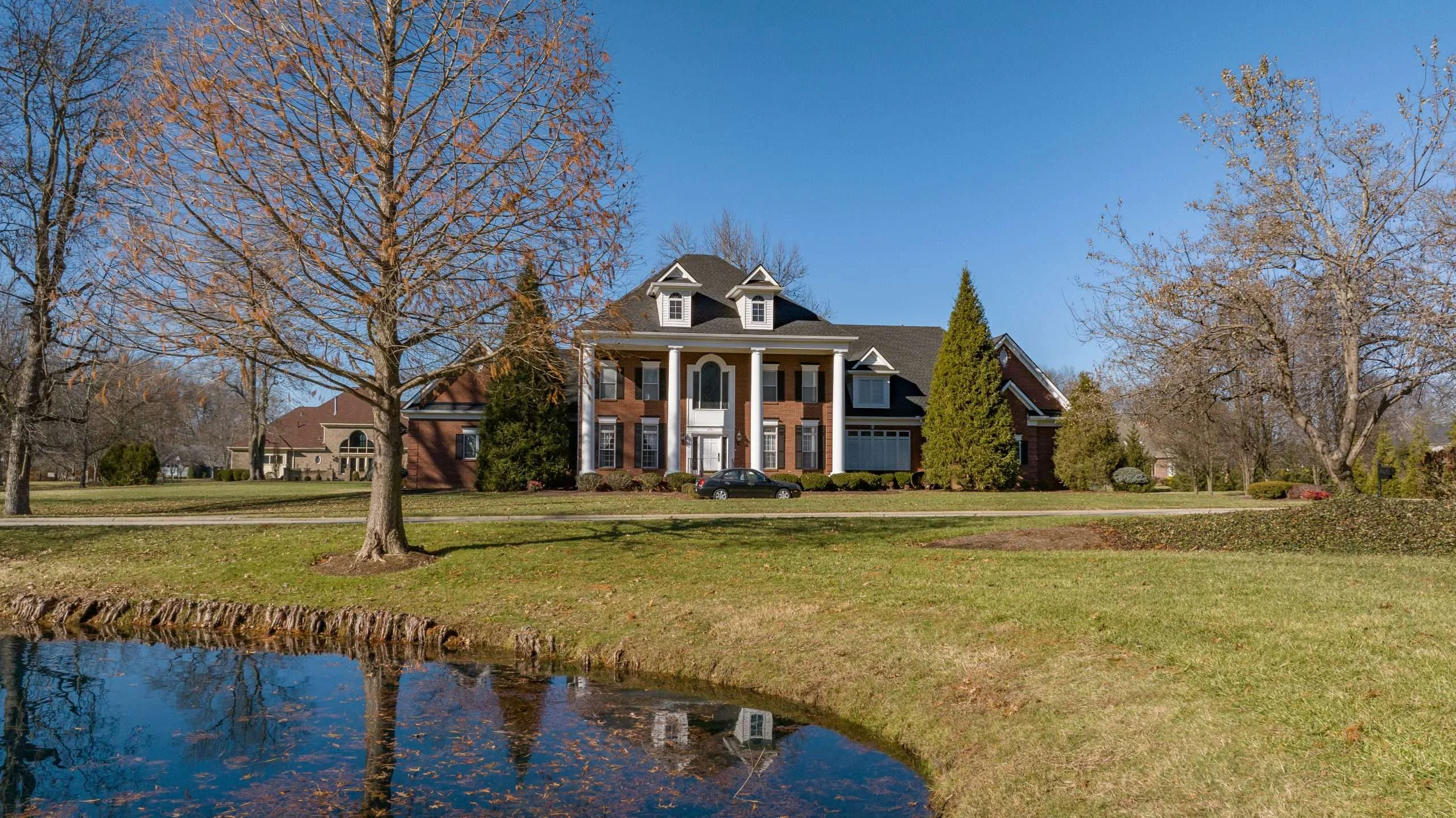 Stunning Prospect KY home with a new roof replacement by AIC Roofing & Construction using GAF Timberline HDZ Charcoal shingles.