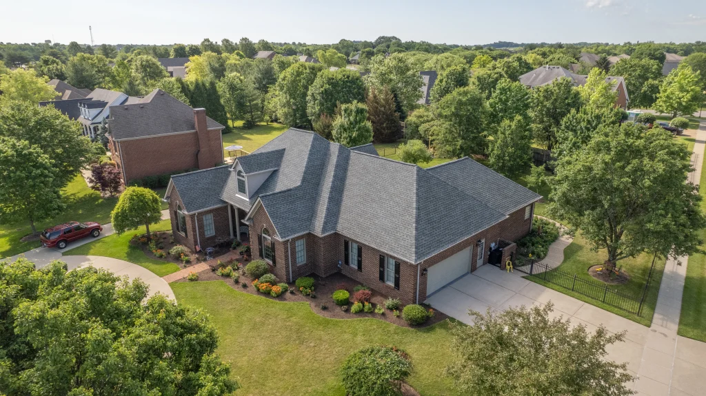 A beautifully landscaped home with a recently installed roof, showcasing expert roof replacement by a professional roofing contractor.