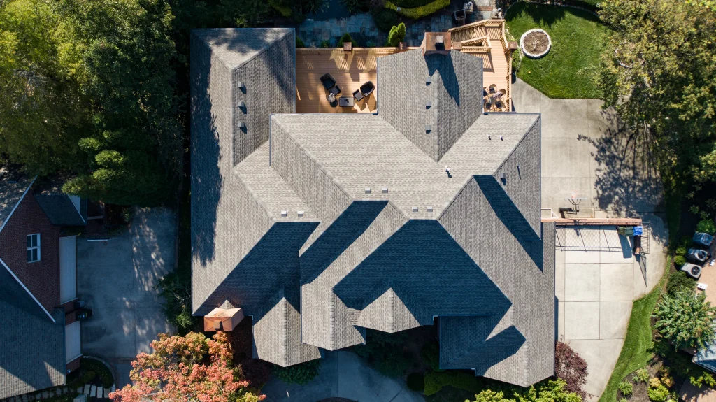 Upgrade your home with discounted premium roofing services. Aerial view of a beautifully replaced roof with intricate designs and clean finish