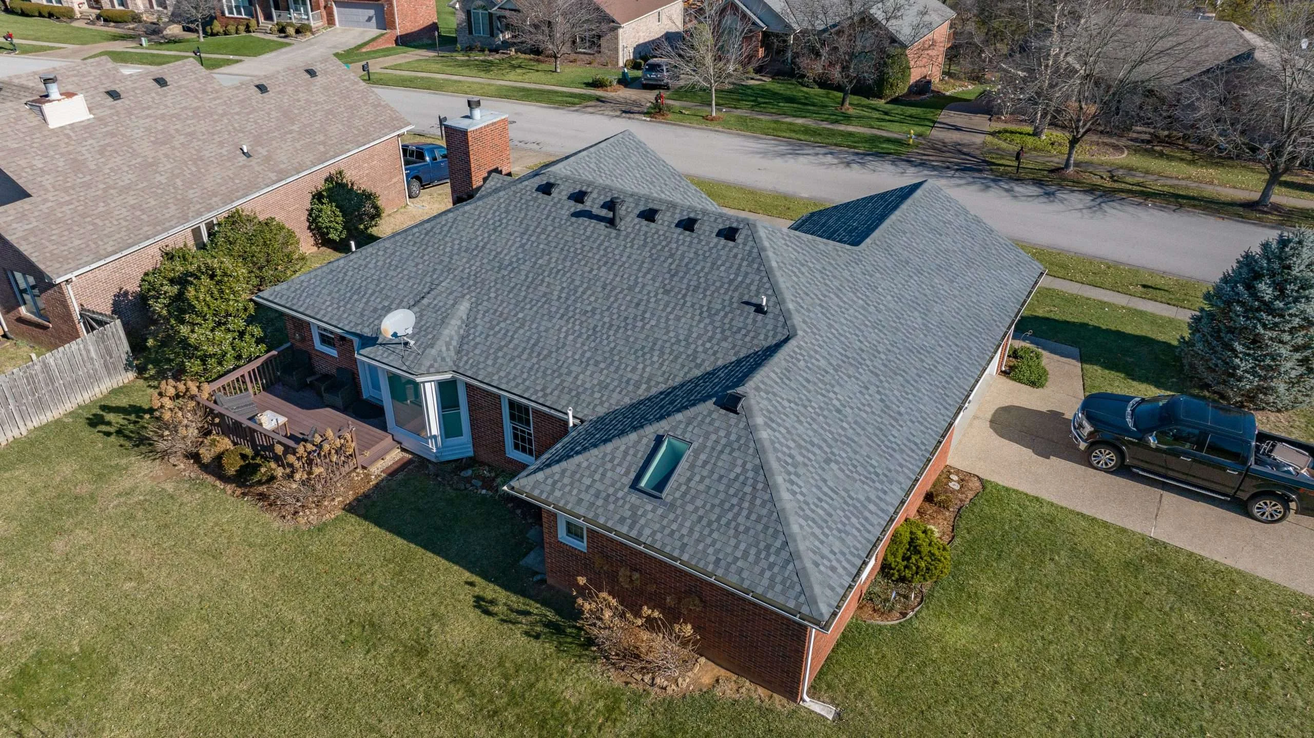 Aerial view of a home featuring a roof replacement with GAF Timberline shingles in Nantucket Morning, installed by a Louisville roofing contractor.