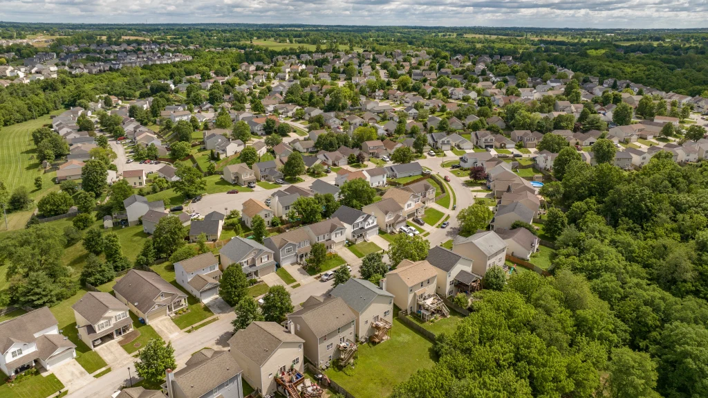 Aerial view of a residential neighborhood with well-maintained roofs, showcasing expert roofing contractor services.