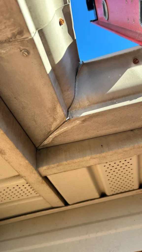 Close-up of damaged corner joint on an old gutter system needing repair or replacement in Lexington, KY.