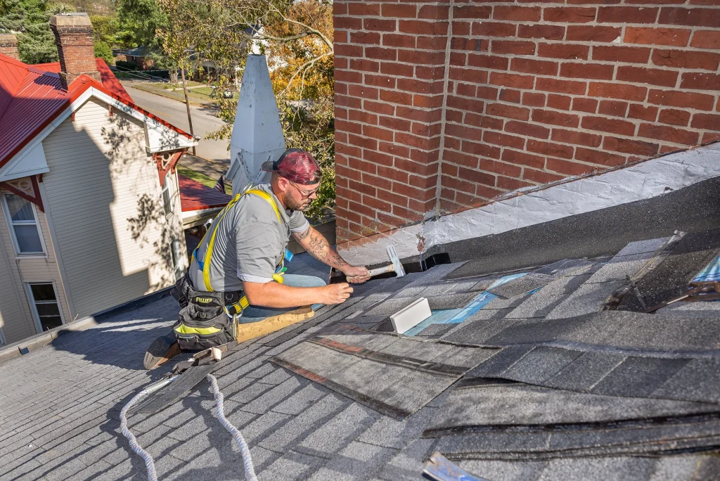 Inage to show roof repair completed Roofer performing detailed roof repair in Lexington, KY.
