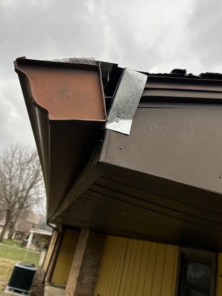 Damaged gutter end cap pulling away from fascia board, indicating the need for gutter repair or replacement in Lexington, KY.