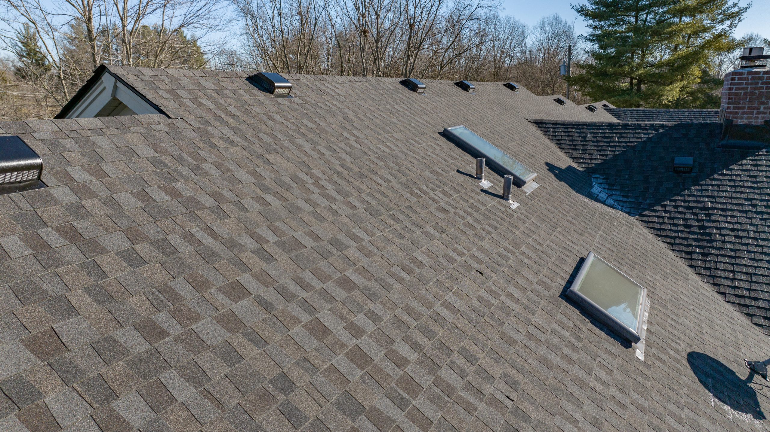 A newly shingled roof with multiple skylights and roof vents—areas often prone to roof leaks in Lexington homes.