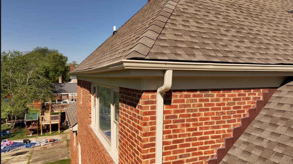 Close-up view of new gutters installed on a La Grange KY brick home, with seamless downspout and fascia detailing.