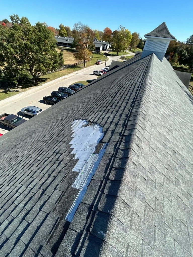example of roof damage Partially repaired shingle roof in Lexington KY showing exposed decking and underlayment during a roof leak repair.