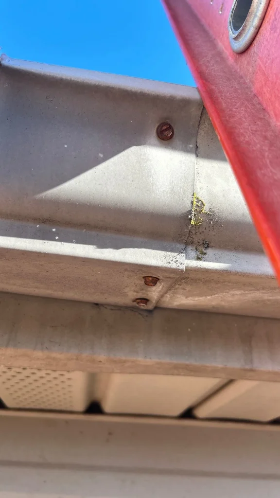 Rusty gutter screws and worn gutter seam on a home in Richmond, KY