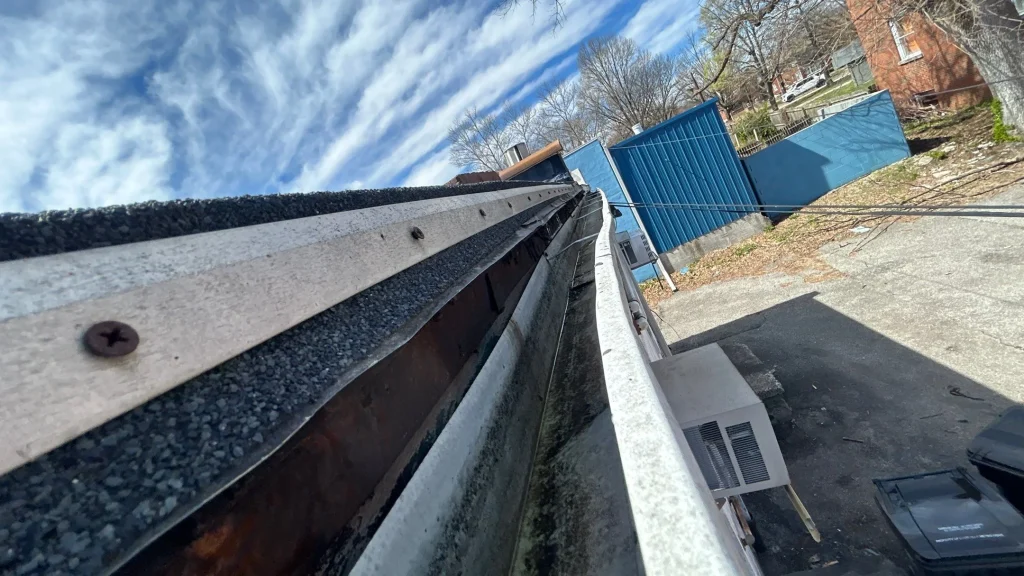 Old, damaged gutters in need of replacement on a commercial building in Louisville, KY.