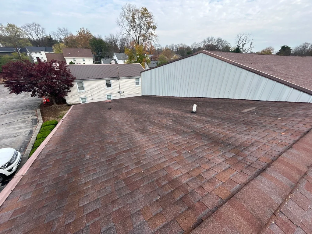 Large commercial building with recently installed red shingle roof in Louisville, KY.