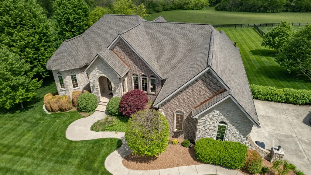 A beautifully maintained brick home with a recently replaced roof, showcasing professional roofing work. Beautiful home with a newly installed asphalt shingle roof by a top-rated roofing company specializing in affordable roofing solutions