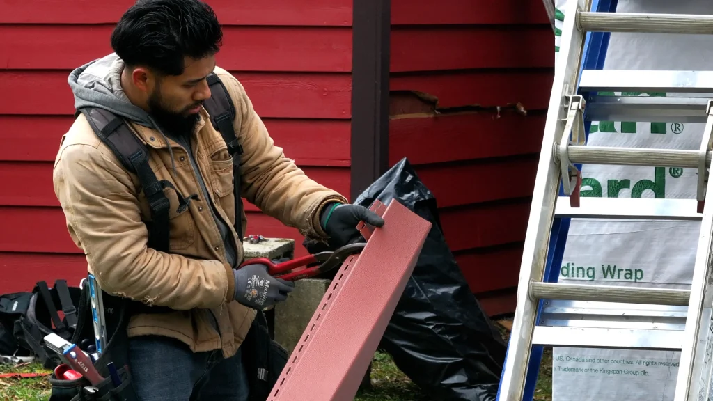Siding contractor in Lexington KY preparing panel for siding installation and repair