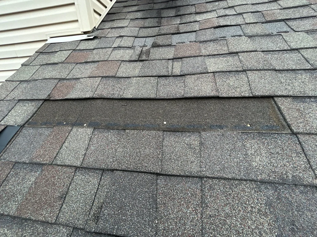 Section of commercial roof with missing shingles in La Grange, KY.