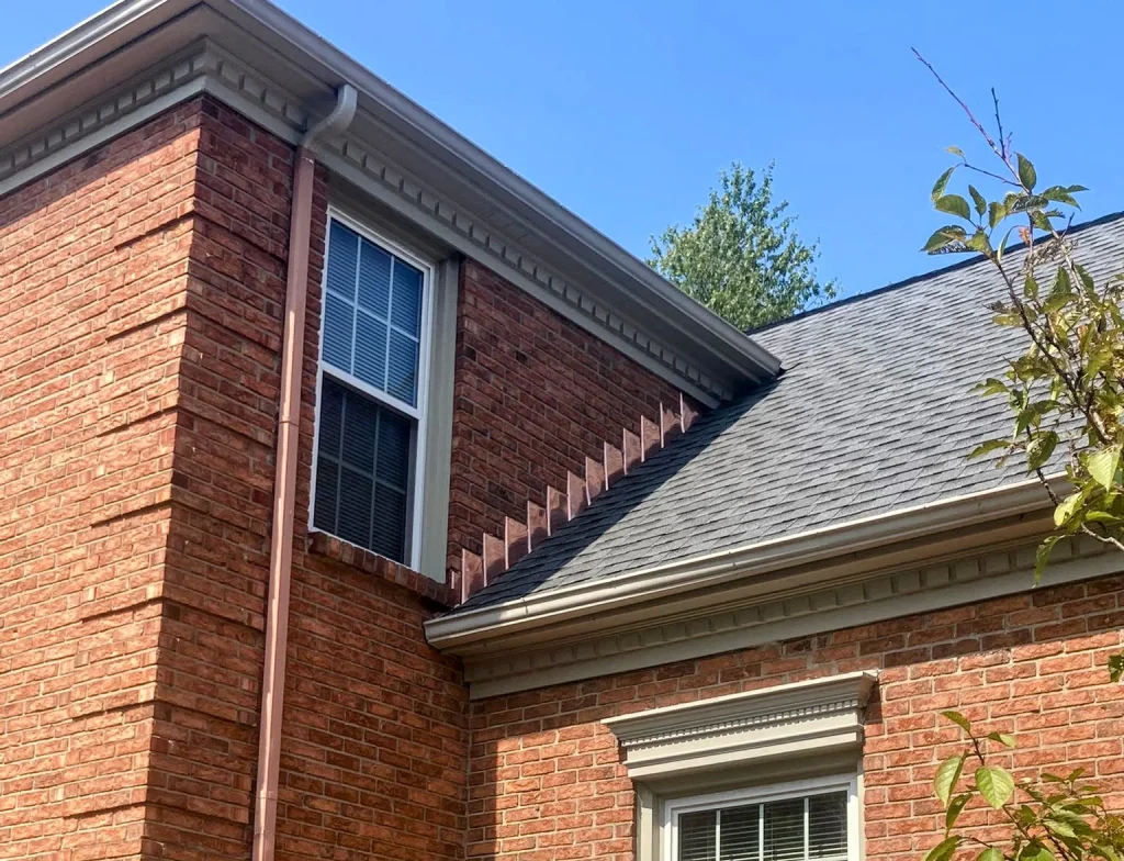 New copper flashing installed at a roof and wall junction on a brick home in Richmond KY
