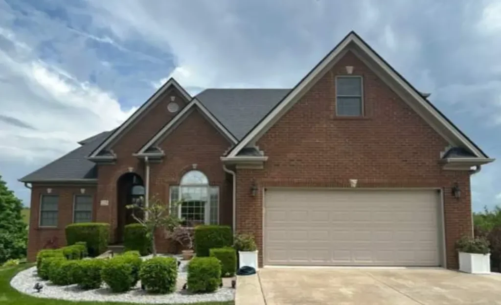A Richmond brick home with a newly replaced roof by AIC Roofing & Construction.


