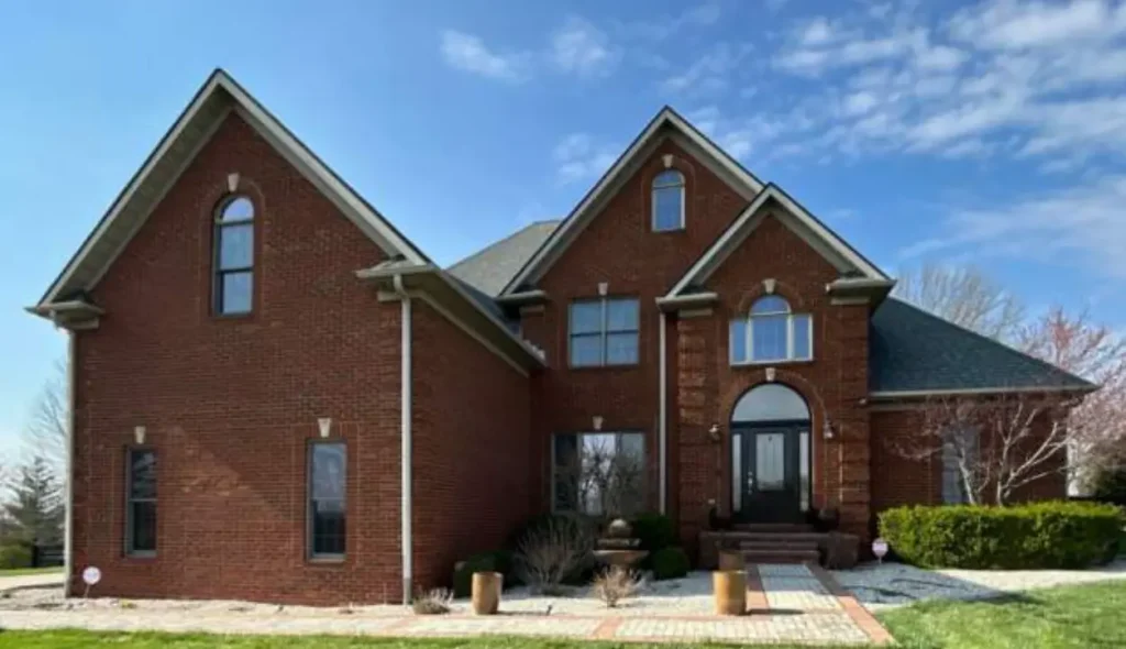 Large brick Richmond home with a new roof replacement completed by AIC Roofing & Construction.
