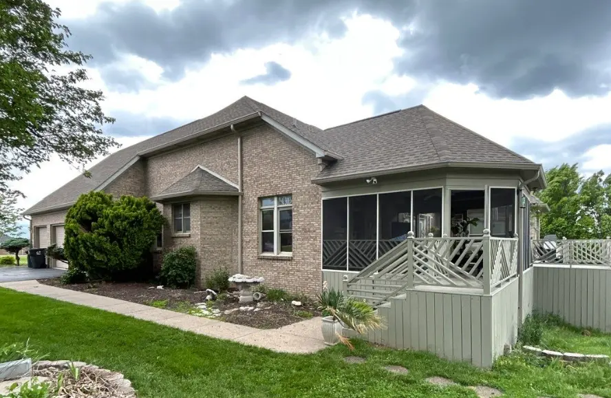 Richmond brick home with a brand-new roof installed by AIC Roofing & Construction.
