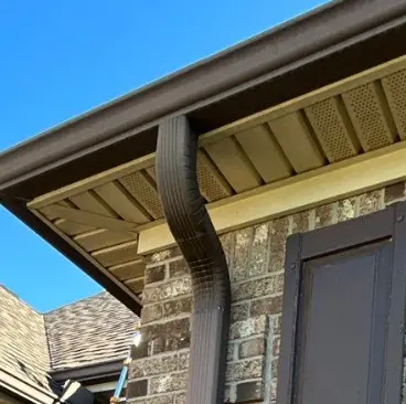 New brown gutter system installed on a Richmond home by AIC Roofing & Construction.