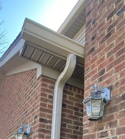 Newly installed white gutter system on a Richmond home by AIC Roofing & Construction.