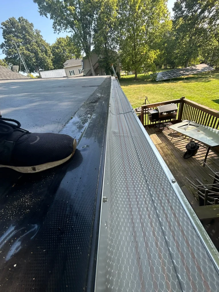 Close-up view of newly installed metal gutter guard on a Kentucky home by AIC Roofing & Construction,