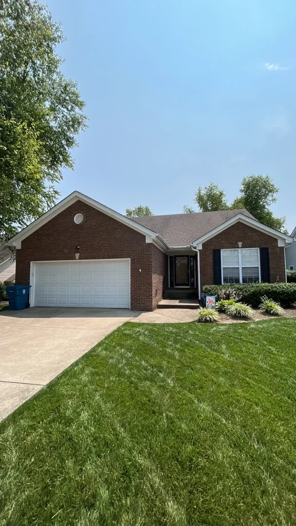 Brick home in Simpsonville, KY with a newly replaced roof by AIC Roofing & Construction.