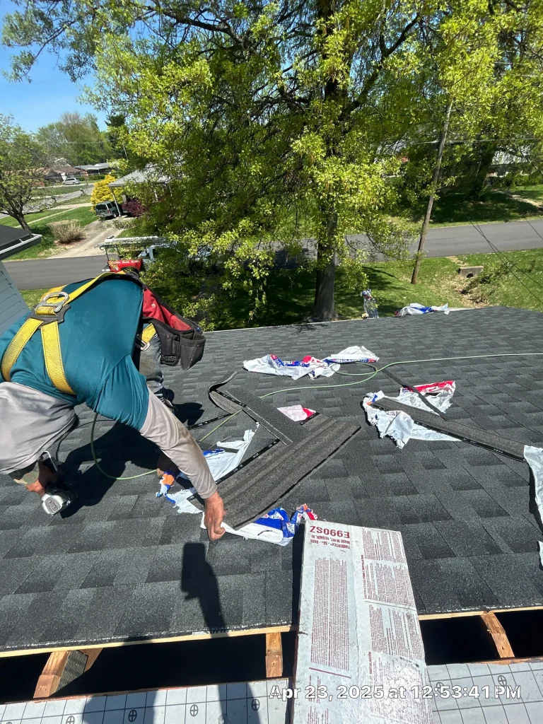 Roofer installing shingles during a roof repair in Louisville, KY by AIC Roofing & Construction.