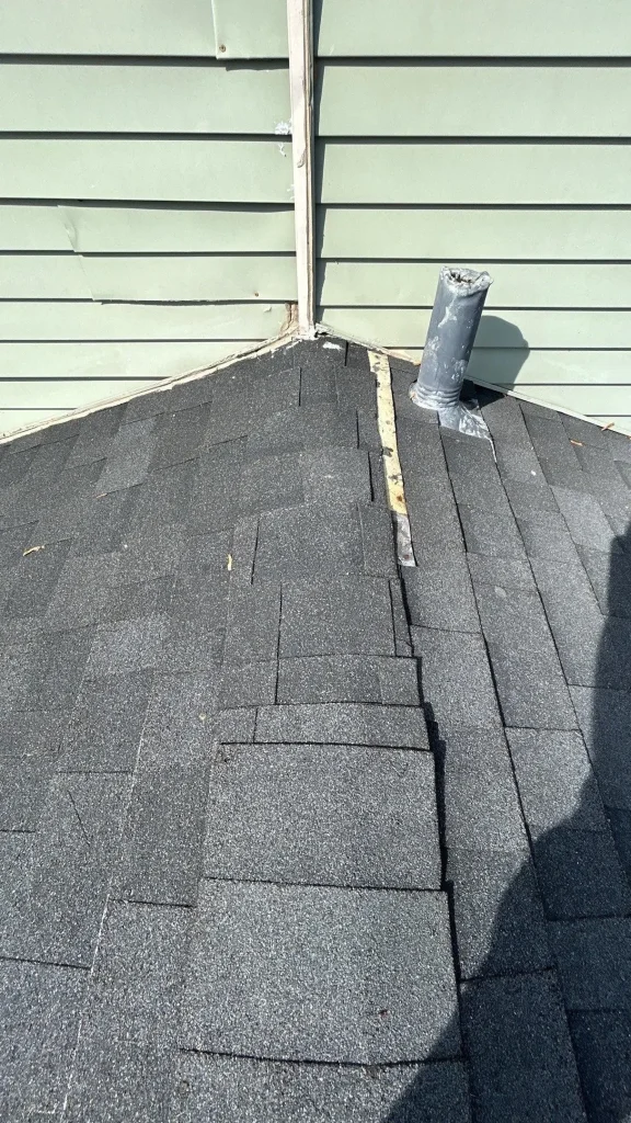 Close-up of a partially repaired roof and siding area on a Jeffersonville, IN home by AIC Roofing & Construction.