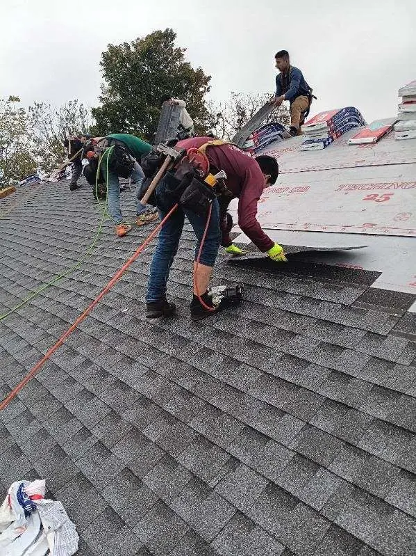 Roofers from AIC Roofing & Construction repairing a shingle roof on a home in Harrodsburg, KY