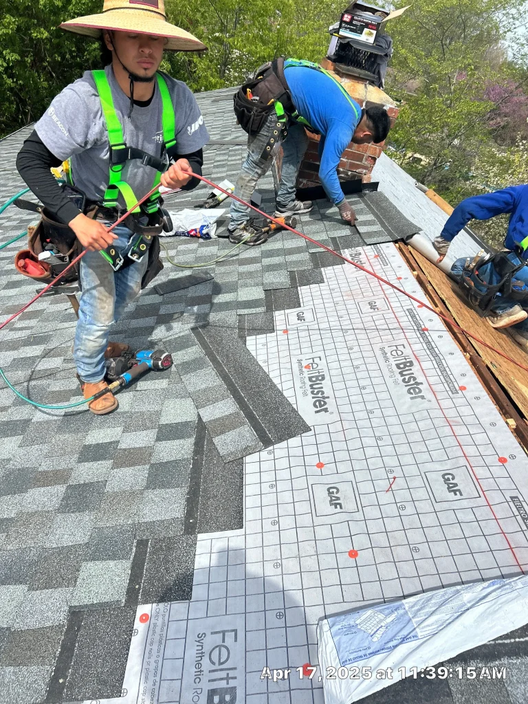 Roof repair in progress on a Nicholasville, KY home, with AIC Roofing crew installing new shingles over GAF FeltBuster underlayment.